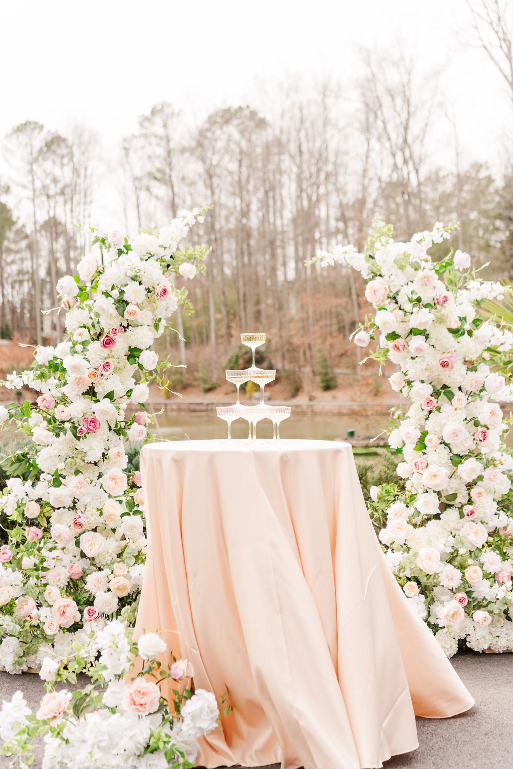 Close-up of Everly pillars showcasing romantic faux roses, ranunculus, and airy filler florals in timeless, neutral tones.