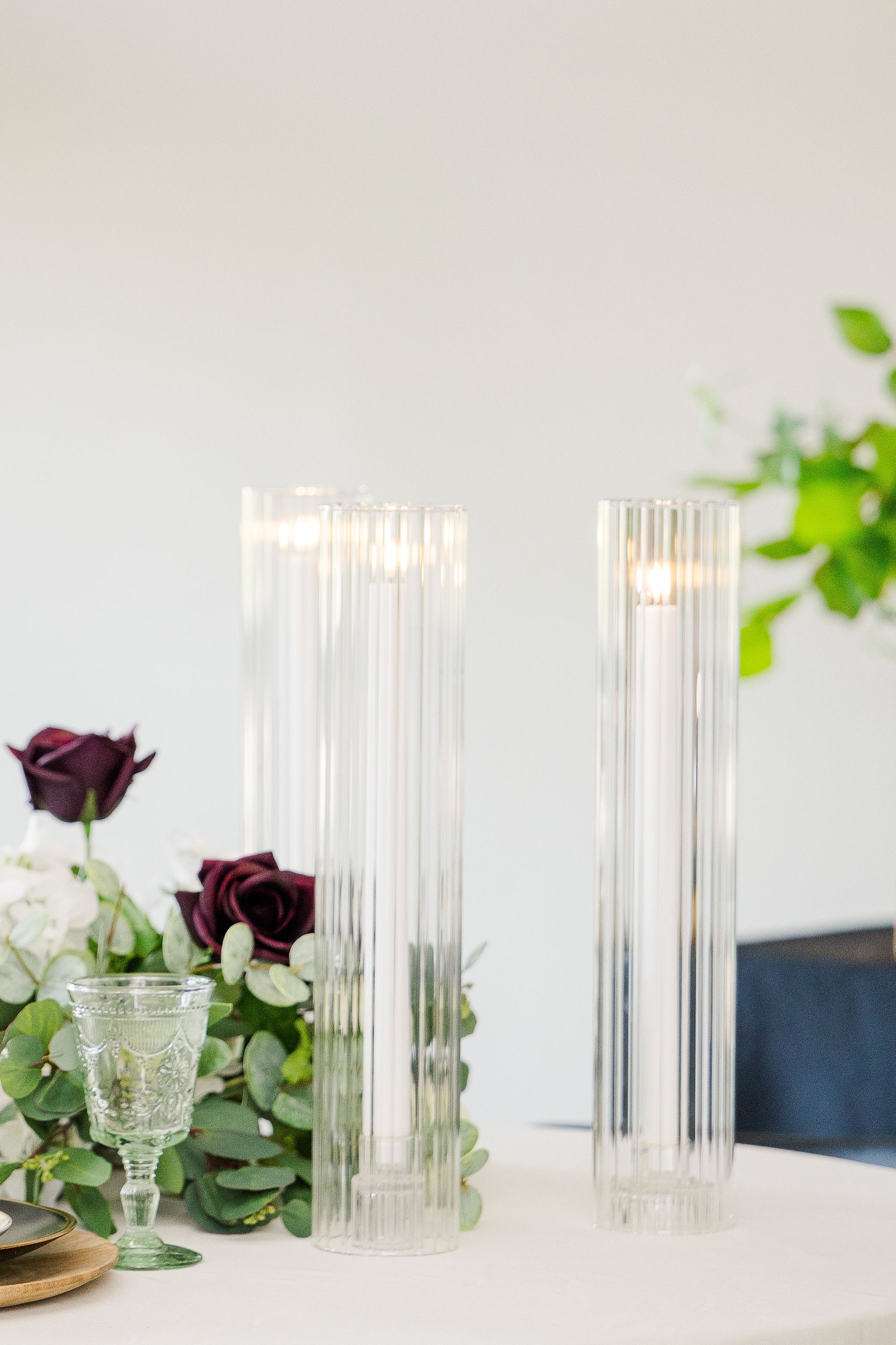 Elegant LED taper candle set with ribbed glass cylinders in 11" and 14", perfect for romantic wedding tablescapes or evening event decor.
