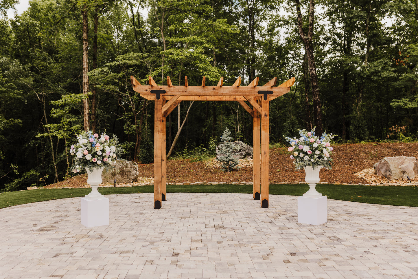Two Wildflower urns marking the ceremony space, adding a bold pop of color and texture to the ceremony entrance.