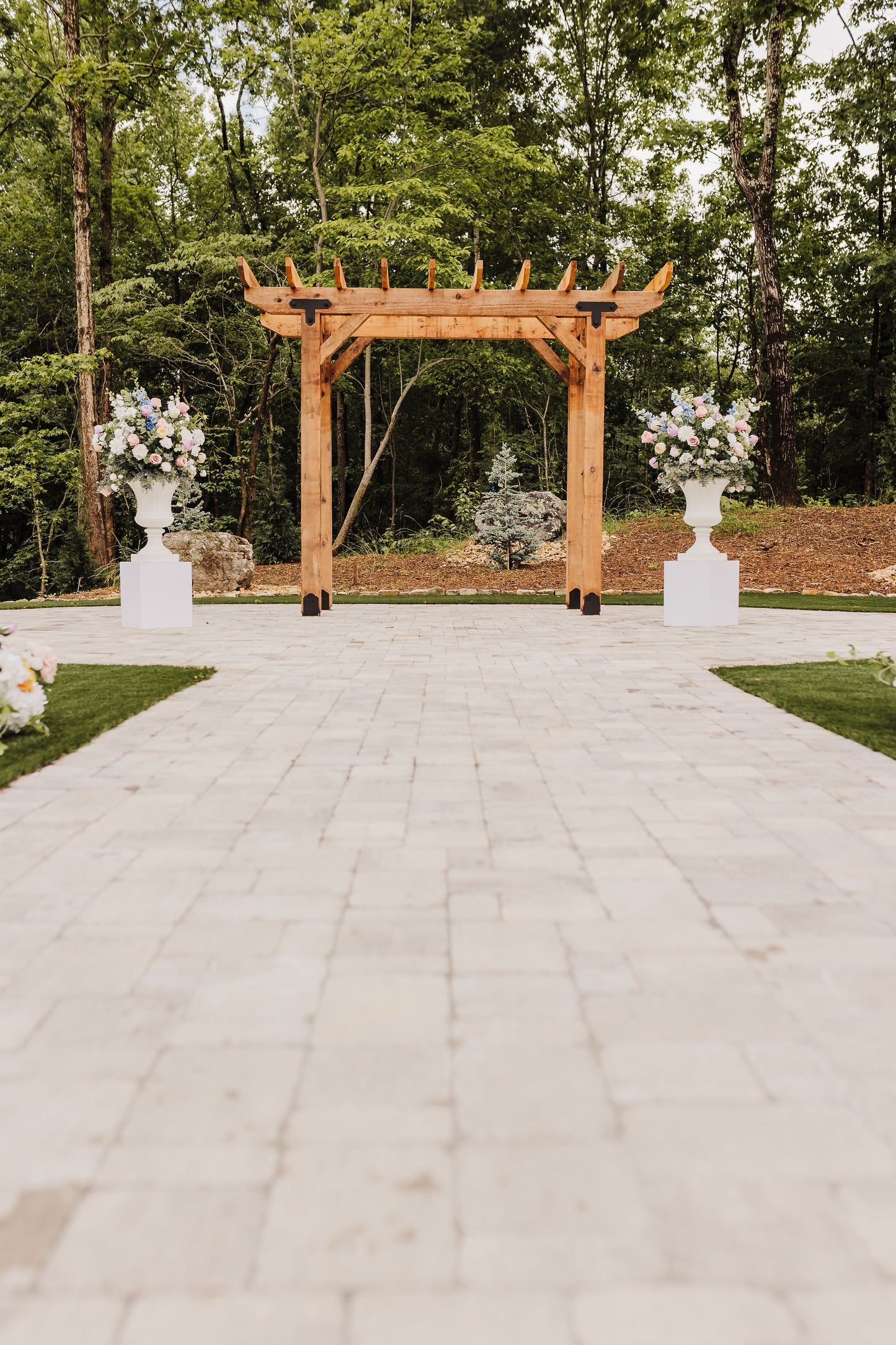 Wildflower urn set used as altar arrangements for a colorful spring or summer wedding ceremony, bringing charm and elegance to the setting.