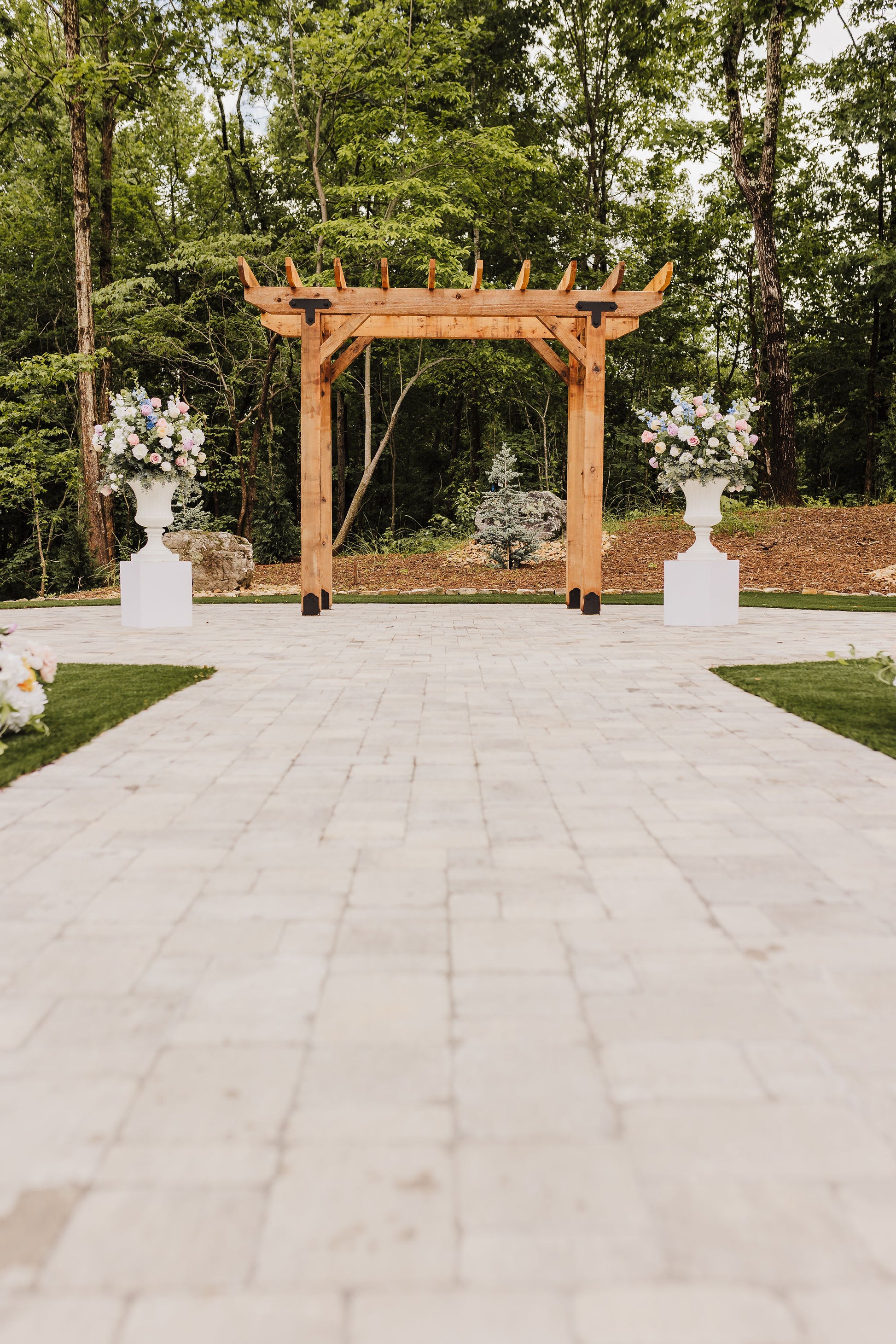 Wildflower urn set used as altar arrangements for a colorful spring or summer wedding ceremony, bringing charm and elegance to the setting.