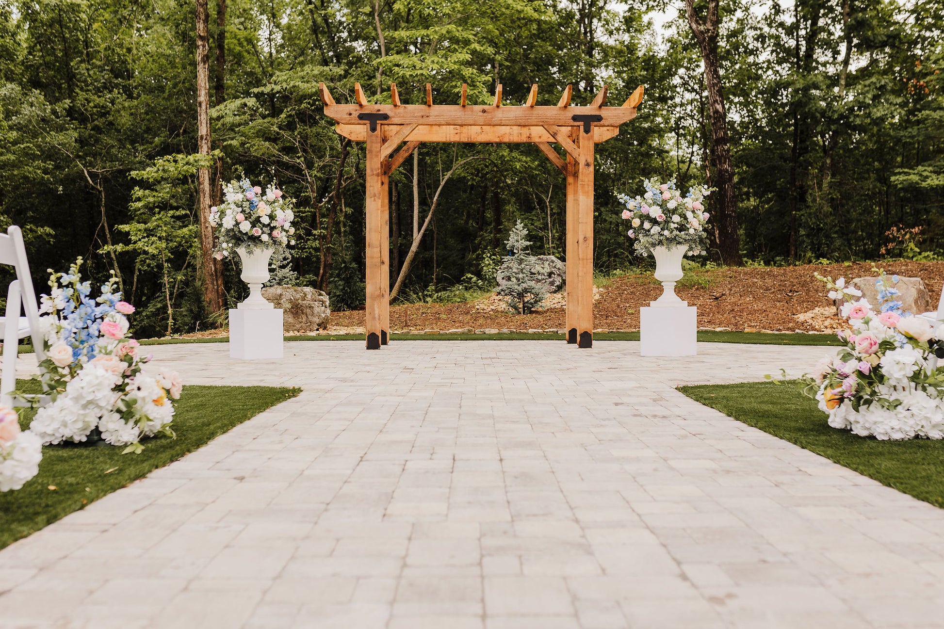 Elegantly styled ceremony space with color forward blooms