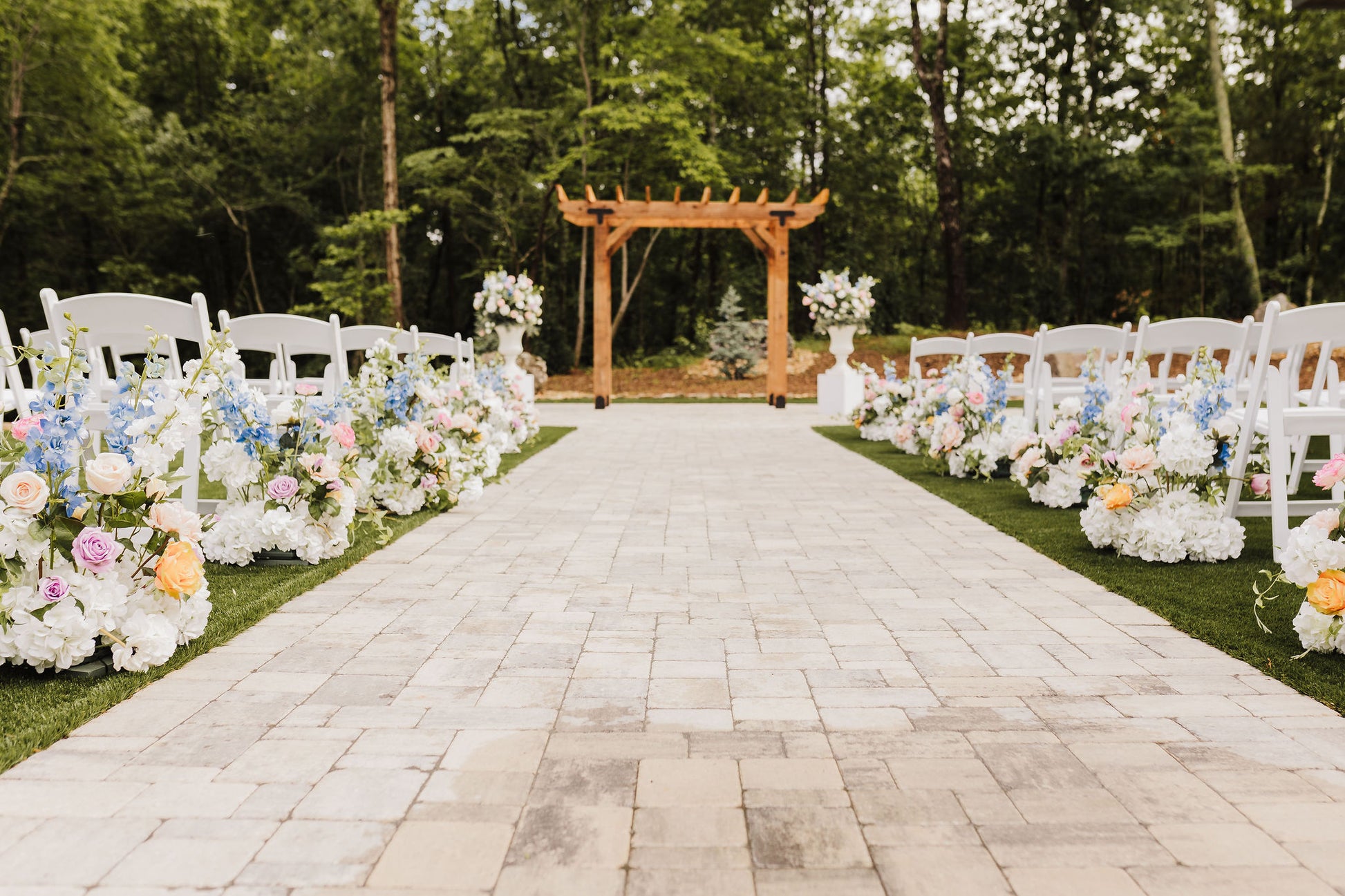 Wildflower aisle bouquets lining a wedding aisle, creating a cheerful and organic path to the altar with lush faux blooms.