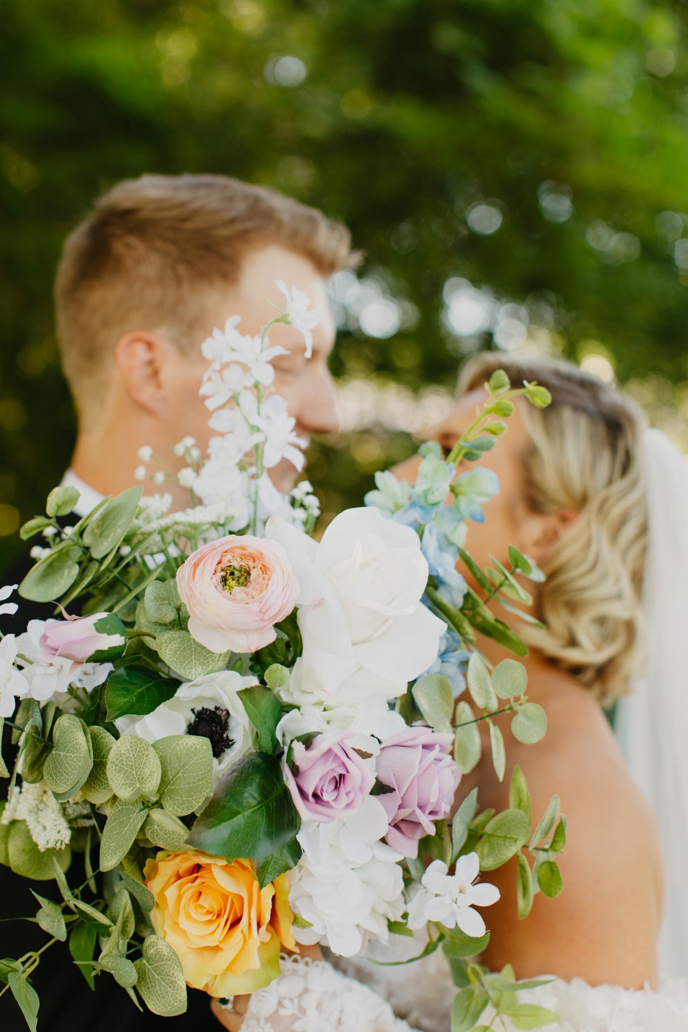 Lively wildflowers gathered bridal bouquet for spring or summer wedding.