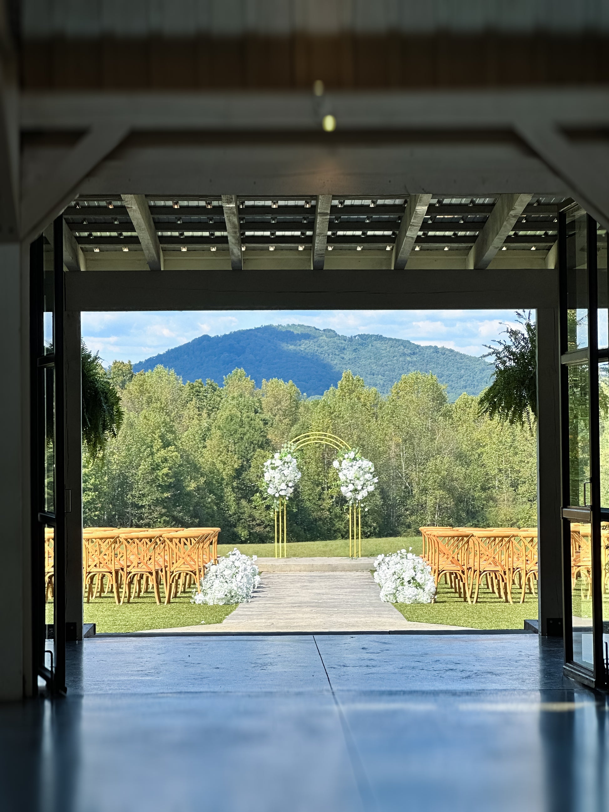 Sleek golden arch with optional floral accents, ideal for minimalist or modern wedding ceremonies.